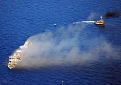 Aerial bow view of the artificial reef Gen. Hoyt S. Vandenberg with a tub boat in the background